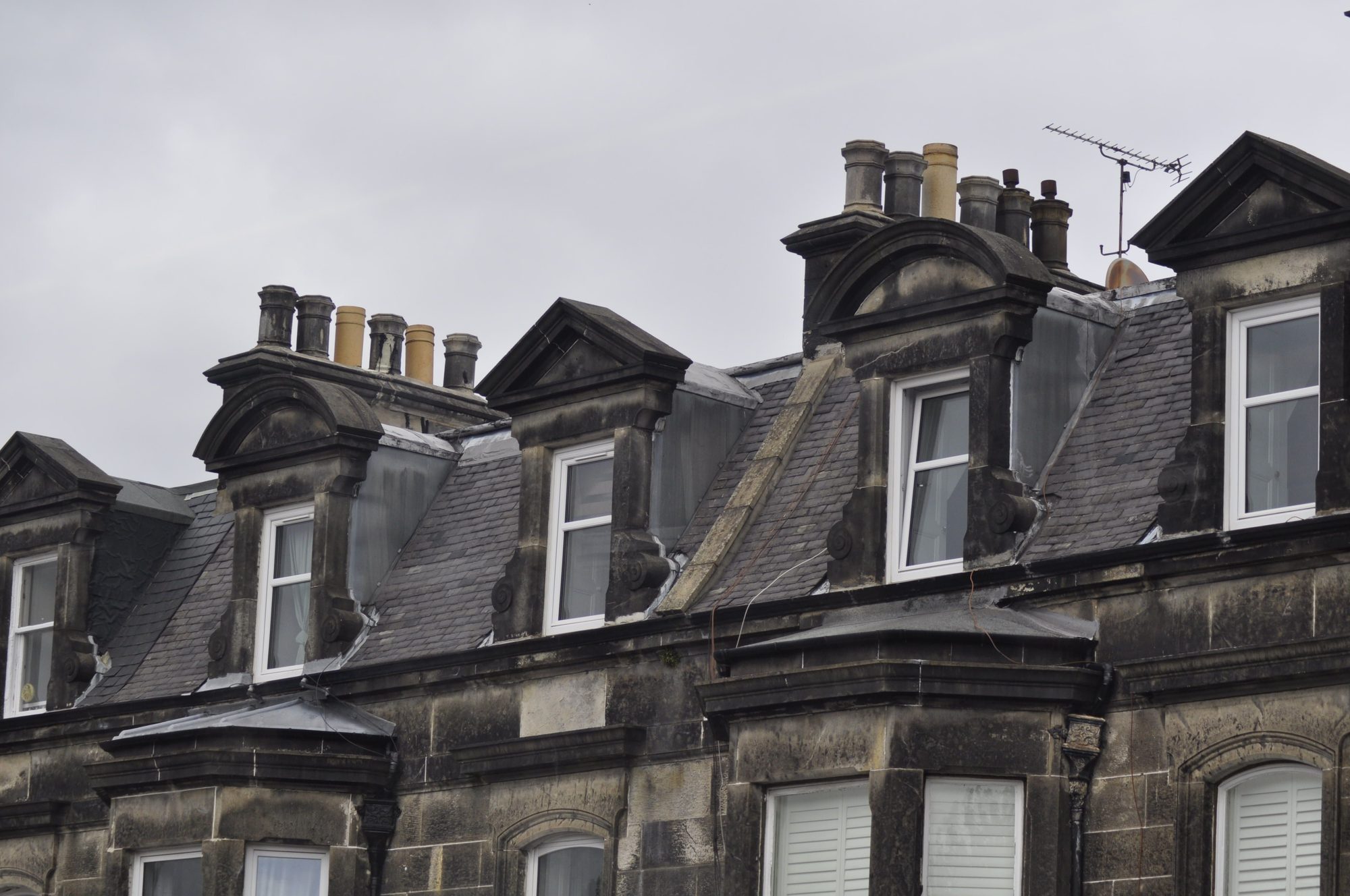 A New Town Edinburgh dormer window set into a slate roof, showing the detail of slate coursing around the dormer cheeks